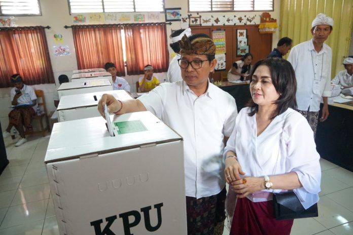 Sekda Adi Arnawa bersama istri Ni Putu Rasniathi menggunakan hak pilihnya di TPS 009, SD Nomor 4 Pecatu, Desa Pecatu, Kecamatan Kuta Selatan, Badung, Rabu 14 Februari 2024