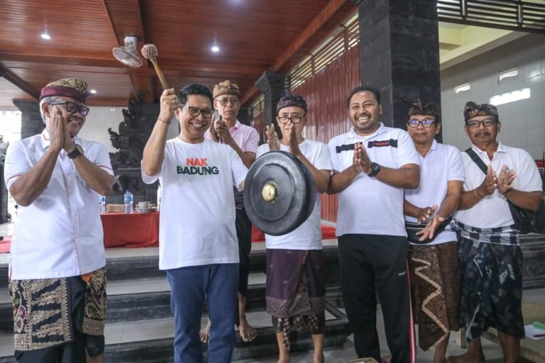 Sekda Wayan Adi Arnawa saat menghadiri sekaligus membuka Turnamen Ceki Pura Pangrurah Sakti Dalem Simping ditandai dengan memukul Gambelan di Balai Banjar Kaja Kangin Cemagi Mengwi Badung, Minggu (14/7).